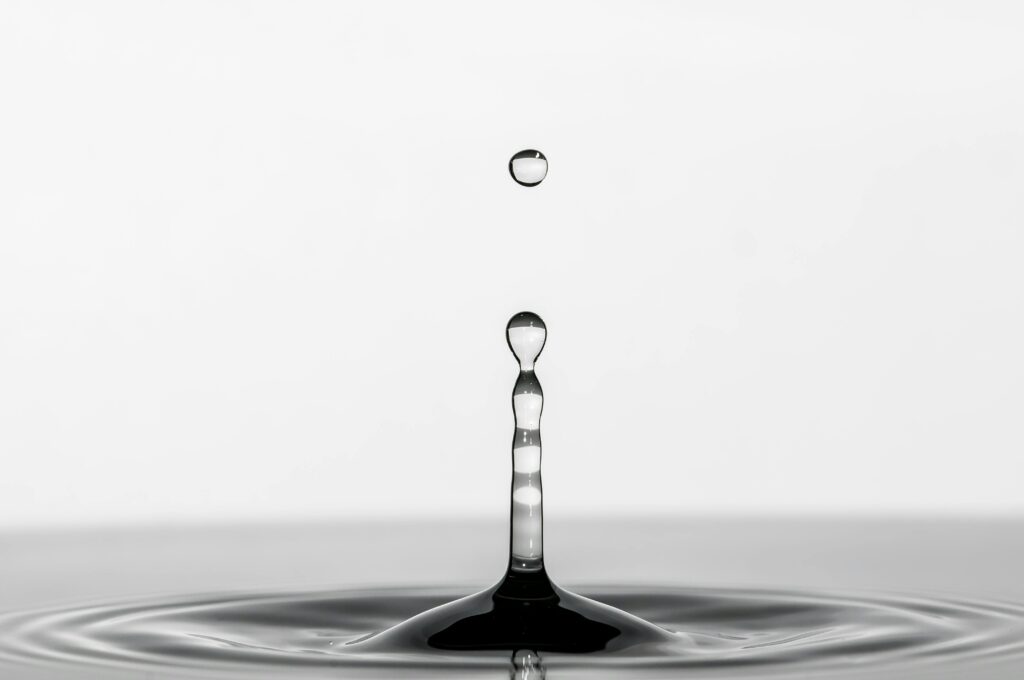 Mesmerizing macro shot capturing a perfect water drop splash with elegant simplicity.